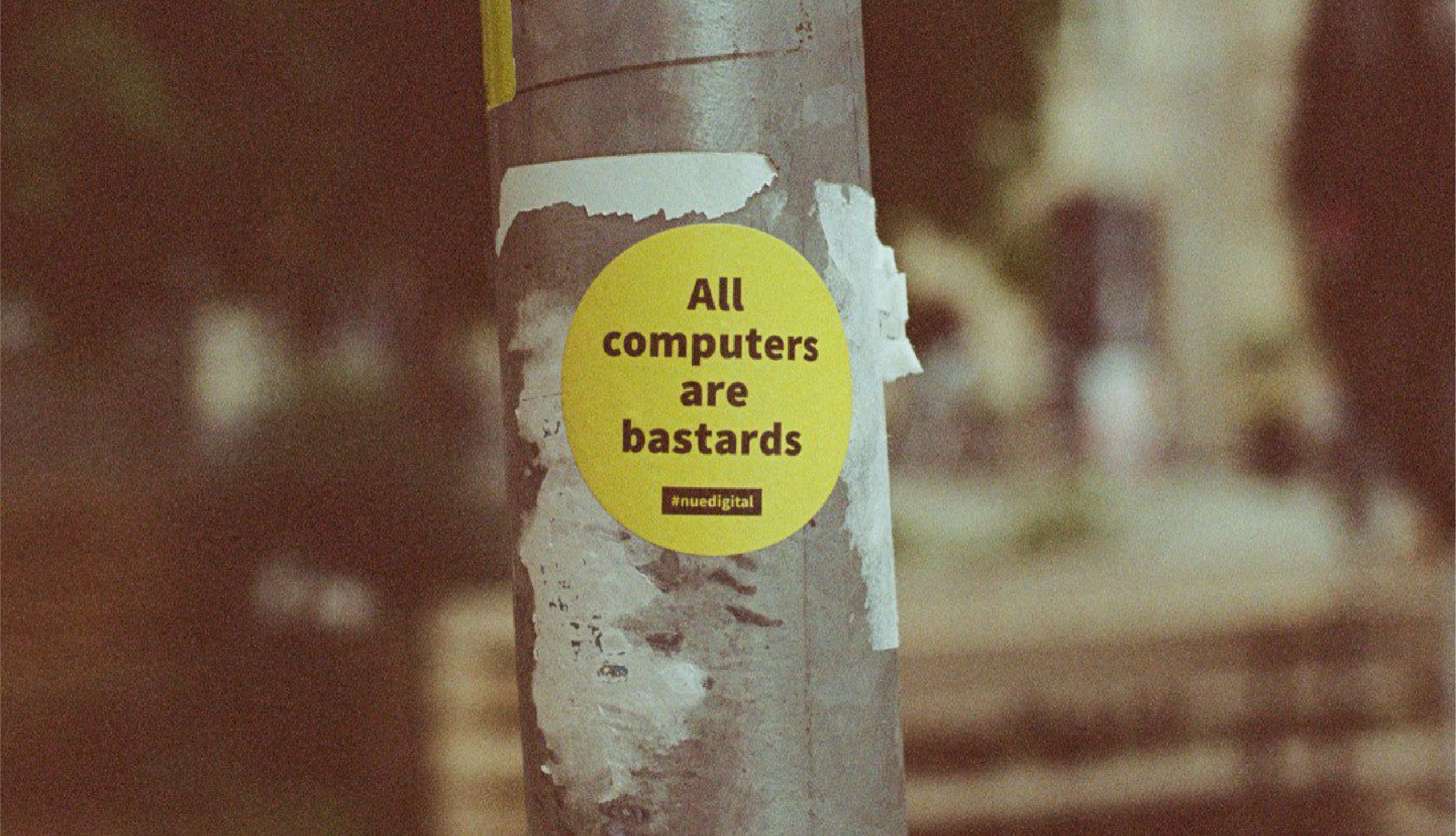 A sticker on a pole that says All computers are bastards